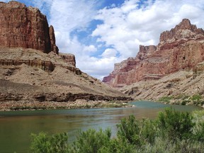 This undated photo provided by Confluence Partners, LLC, shows a view upstream on the Colorado River in the Grand Canyon at the site for a proposed aerial tram. Navajo Nation lawmakers will consider a plan Tuesday, Oct. 31, 2017, to build an aerial tram to carry visitors to the bottom of the Grand Canyon. The special session in Window Rock, Ariz., will be the first time the full Tribal Council takes up the bill. (Confluence Partners, LLC via AP)