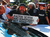 Protesters surround a police cruiser on Saturday Sept. 30, 2017 in Peterborough, Ont.