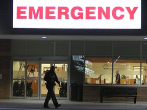 A police officer walks by the emergency entrance of Northumberland Hills Hospital. Two people are dead following a shooting at Northumberland Hills Hospital at approximately 11 p.m. on October 27, 2017 in Cobourg, Ont.