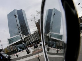 The European Central Bank is reflected in a scooter mirror during a press conference of ECB President Mario Draghi in Frankfurt, Germany, Thursday, Oct. 26, 2017. (AP Photo/Michael Probst)