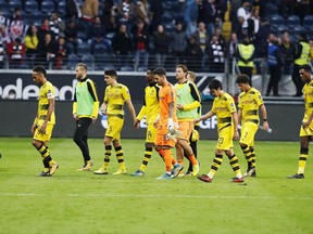 Dortmund players leave the pitch after a German first division Bundesliga match between Eintracht Frankfurt and Borussia Dortmund in Frankfurt, Germany, Saturday, Oct. 21, 2017. (AP Photo/Michael Probst)