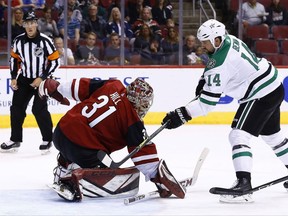 Dallas Stars left wing Jamie Benn (14) scores a goal against Arizona Coyotes goalie Adin Hill (31) during the first period of an NHL hockey game Thursday, Oct. 19, 2017, in Glendale, Ariz. (AP Photo/Ross D. Franklin)