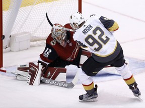 Vegas Golden Knights left wing Tomas Nosek (92) shoots the puck off the post as Arizona Coyotes goalie Antti Raanta (32) slides over to defend the net during the first period of an NHL hockey game Saturday, Oct. 7, 2017, in Glendale, Ariz. (AP Photo/Ross D. Franklin)