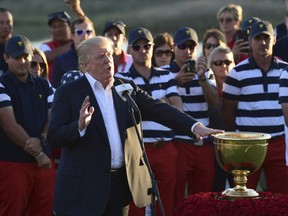 President Donald Trump speaks before presenting the winner's trophy to the U.S. Team after the final round of the Presidents Cup at Liberty National Golf Club in Jersey City, N.J., Sunday, Oct. 1, 2017.
