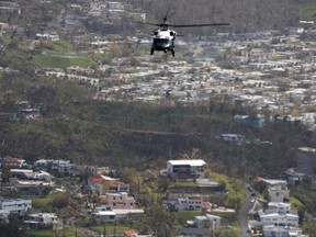 Marine One helicopter carrying President Donald Trump surveys areas impacted by Hurricane Maria, Tuesday, Oct. 3, 2017, near San Juan, Puerto Rico. (AP Photo/Evan Vucci)