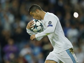 Real Madrid's Cristiano Ronaldo kisses the ball after scoring a penalty during a Group H Champions League soccer match between Real Madrid and Tottenham Hotspur at the Santiago Bernabeu stadium in Madrid, Tuesday Oct. 17, 2017. (AP Photo/Paul White)