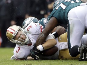 San Francisco 49ers' C.J. Beathard (3) is tackled by Philadelphia Eagles' Brandon Graham, back, during the first half of an NFL football game, Sunday, Oct. 29, 2017, in Philadelphia,. (AP Photo/Michael Perez)