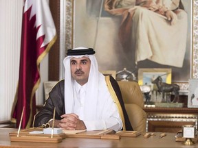 FILE- In this Friday, July21, 2017, file photo, Emir of Qatar Sheikh Tamim bin Hamad Al Thani talks in his first televised speech since the dispute between Qatar and three Gulf countries and Egypt, in Doha, Qatar. Qatar's emir has warned against any military confrontation over the ongoing diplomatic dispute between his country and four other Arab nations, saying it will only engulf the region in chaos. (Qatar News Agency via AP, File)