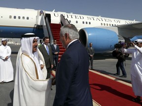 U.S. Secretary of State Rex Tillerson, center, is greeted before boarding his plane for Pakistan, Tuesday, Oct. 24, 2017, in Doha, Qatar. (AP Photo/Alex Brandon, Pool)