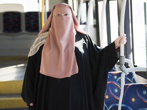 Warda Naili poses for a photograph on a city bus in Montreal, Saturday, October 21, 2017.