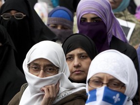 Quebec women attend a protest in 2010.