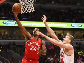 Toronto Raptors guard Norman Powell (left) shoots past Chicago Bulls forward Lauri Markkanen on Oct. 13.