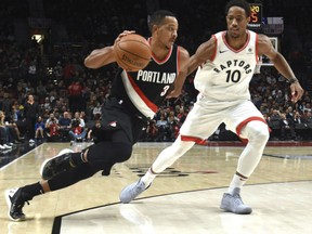 C.J. MCCollum of the Portland Trail Blazers tries to drive past the defence of DeMar ReRozan of the Toronto Raptors during NBA action Monday night in Portland. Despite missing two of their starters, the Raptors pulled off the 99-85 upset led by DeRozan's 25 points.