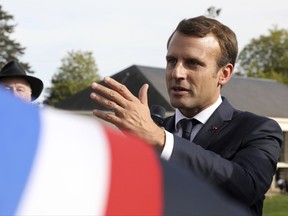 French President Emmanuel Macron, gestures during a visit at the School of Application to the Trades of Public Works (EATP), which is devoted to apprenticeship and vocational training, in Egletons, central France, Wednesday, Oct. 4, 2017. (Ludovic Marin/Pool Photo via AP)