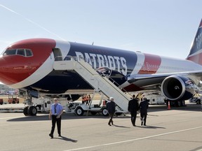 The New England Patriots customized Boeing 767 passenger jet sits on the tarmac, Wednesday, Oct. 4, 2017, at T.F. Green Airport, in Warwick, R.I. The NFL football team are to fly in the aircraft, which is painted with the team's logo and red-white-and-blue colors, and includes the Pats' five Lombardi trophies painted on the tail, on their way to Florida, where they play the Tampa Bay Buccaneers on Thursday, Oct. 5. (AP Photo/Steven Senne)
