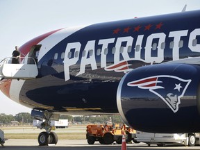 The New England Patriots customized Boeing 767 passenger jet sits on the tarmac, Wednesday, Oct. 4, 2017, at T.F. Green Airport, in Warwick, R.I. The NFL football team are to fly in the aircraft, which is painted with the team's logo and red-white-and-blue colors, and includes the Pats' five Lombardi trophies painted on the tail, on their way to Florida, where they play the Tampa Bay Buccaneers on Thursday, Oct. 5. (AP Photo/Steven Senne)