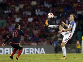 U.S player James Sands duels for the ball against Colombia's Brayan Gomez during the FIFA U-17 World Cup match in Mumbai, India, Thursday, Oct. 12, 2017. (AP Photo/Rajanish Kakade)