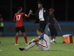 United States' Matt Besler, squats on the pitch after losing 2-1 against Trinidad and Tobago during a 2018 World Cup qualifying soccer match  in Couva, Trinidad, Tuesday, Oct. 10, 2017. (AP Photo/Rebecca Blackwell)