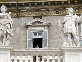 Pope Francis waves to faithful from his studio's window overlooking St. Peter's Square at the Vatican, Sunday, Oct. 29, 2017. (AP Photo/Gregorio Borgia)