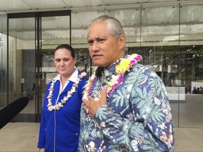 Former Honolulu police chief Louis Kealoha, right, and his wife, city deputy prosecutor Katherine Kealoha speak to media outside U.S. District Court in Honolulu on Friday, Oct. 20, 2017. The Kealohas and current and former police officers conspired to frame the couple's relative for stealing a mailbox to discredit him in a family financial dispute, according to a federal indictment released Friday. (AP Photo/Audrey McAvoy)