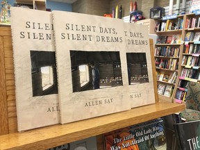 In this Tuesday, Oct. 31, 2017 photo, copies of Allen Say's "Silent Days, Silent Dreams" sit on a bookshelf at a store in Boise, Idaho. The fictional biography of self-taught Idaho artist James Castle went on sale Tuesday after a federal judge ruled Monday that the award-winning children's book author from Oregon who created it likely didn't violate copyright laws. (AP Photo/Keith Ridler)