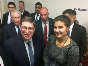 Cuban Foreign Minister Bruno Rodriguez, left, talks to Cuban nationals who live in the United States on Saturday Oct. 28, 2017, in Washington. (AP photo/Luis Alonso Lugo)