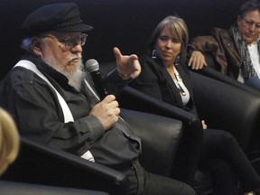 Author and film producer George R. R. Martin, left, speaks in Santa Fe, N.M., Thursday, Oct. 19, 2017. Martin waded into the politics of movie-industry tax breaks on Thursday while endorsing a prominent Democratic candidate for governor of New Mexico. (AP Photo/Morgan Lee)