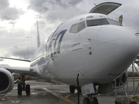 Alaska Airlines unveils the first passenger plane to be converted to a cargo jet, Monday, Oct. 2, 2017, in Anchorage, Alaska. The 737-700s will increase cargo capacity by 20 percent in Alaska, and spell the end of the airline's unique combi planes, which are 737-400 planes configured to be half-passenger, half-cargo. (AP Photo/Mark Thiessen)