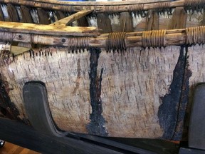 One of the oldest-known Native American birch-bark canoes, dated from the mid-1700's, is displayed at the Pejepscot Museum & Research Center in Brunswick, Maine, Thursday Oct. 5, 2017.   The society came into the possession of it in 1889. It had spent three decades in a barn before being placed in the museum.  (AP Photo/Patrick Whittle)