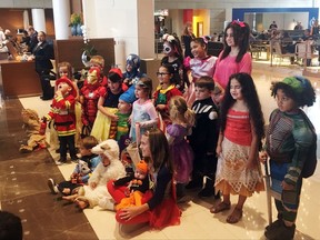 Children of the Houston Astros baseball team pose for a photo in Halloween costumes in the lobby of J.W. Marriott L.A. Live hotel in Los Angeles. (AP Photo/Ron Blum)