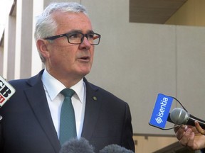 Australian lawmaker Andrew Wilkie addresses the media outside Parliament House in Canberra Wednesday, Oct. 18, 2017. Wilkie accused a major Australian casino company of rigging slot machines and concealing potential money laundering at its largest casino with the state regulator covering up criminal behavior. (AP Photo/Rod McGuirk)