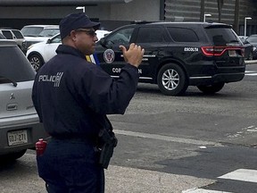 Officer Ulises Villanueva directs traffic at an intersection in San Juan, Puerto Rico, Thursday, Oct. 5 2017. Traffic lights are out across most of the island amid power outages caused by Hurrricane Maria. (AP Photo/Michael Melia)