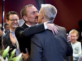 Karl Kreile, left, and Bodo Mende kiss after their marriage in Berlin, Sunday, Oct. 1, 2017. The couple has become the first in Germany to celebrate a same-sex wedding, after a new law called "marriage for all" came into force Sunday. Karl Kreile, 59, and Bodo Mende, 60, were married Sunday morning at the town hall in Schoeneberg, a Berlin district. The law change followed a free vote in Parliament in June, making Germany the 23rd country worldwide to allow same-sex marriages. (Britta Pedersen/dpa via AP)