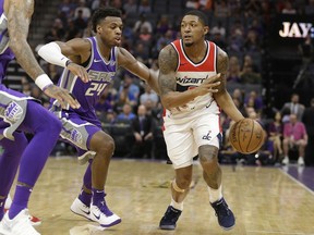 Washington Wizards guard Bradley Beal, right, drives against Sacramento Kings guard Buddy Hield during the first half of an NBA basketball game Sunday, Oct. 29, 2017, in Sacramento, Calif. (AP Photo/Rich Pedroncelli)