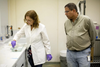Scientists Carolina Moller of the Medical University of South Carolina and Frank MarÃ­ of the National Institute of Standards and Technology observe a cone snail during a recent milking session.