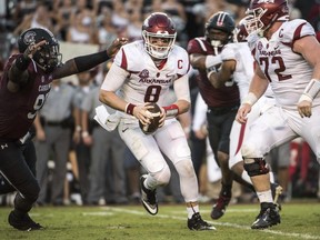 Arkansas quarterback Austin Allen (8) attempts to escape pressure from South Carolina defensive lineman Dante Sawyer, left, during the second half of an NCAA college football game Saturday, Oct. 7, 2017, in Columbia, S.C.  (AP Photo/Sean Rayford)