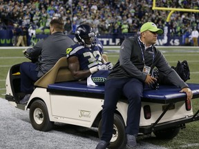 Seattle Seahawks running back Chris Carson (32) taken off on a cart after an injury in the second half of an NFL football game against the Indianapolis Colts, Sunday, Oct. 1, 2017, in Seattle.(AP Photo/Stephen Brashear)