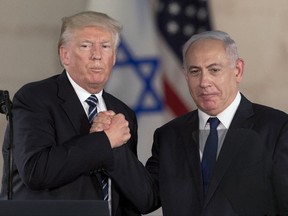 FILE - In this Tuesday, May 23, 2017 file photo, Israeli Prime Minister Benjamin Netanyahu, right, and US President Donald Trump shake hands at the Israel Museum in Jerusalem. (AP Photo/Sebastian Scheiner, File)