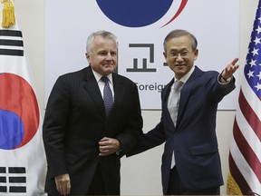U.S. Deputy Secretary of State John Sullivan, left, is greeted by South Korea Vice Foreign Minister Lim Sung-nam prior to their bilateral meeting at Foreign Ministry in Seoul, South Korea, Wednesday, Oct. 18, 2017. (AP Photo/Ahn Young-joon)