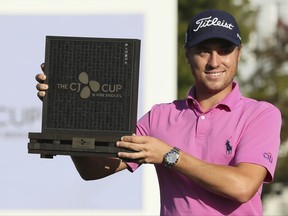 Winner Justin Thomas of the United States poses with his trophy after winning the CJ Cup golf tournament at Nine Bridges on Jeju Island, South Korea, Sunday, Oct. 22, 2017. (Park Ji-ho/Yonhap via AP)