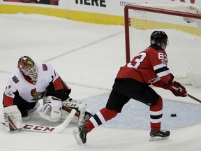 Devils forward Jesper Bratt  scores the winning goal  past Ottawa Senators goalie Mike Condon during a shootout in their game Friday in Newark, N.J.