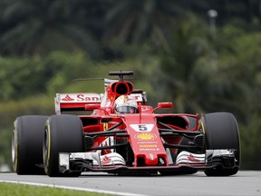 Ferrari driver Sebastian Vettel of Germany steers hi scar during the Malaysian Formula One Grand Prix at the Sepang International Circuit in Sepang, Malaysia, Sunday, Oct. 1, 2017. (AP Photo/Vincent Thian)
