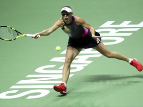Caroline Wozniacki of Denmark makes a forehand return against Venus Williams of the United States during their singles final match at the WTA tennis tournament in Singapore, on Sunday, Oct. 29, 2017. (AP Photo/Yong Teck Lim)