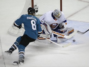 New York Islanders goalie Thomas Greiss stops a shot by San Jose Sharks center Joe Pavelski (8) during the second period of an NHL hockey game Saturday, Oct. 14, 2017, in San Jose, Calif. (AP Photo/Eric Risberg)