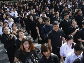 Thai mourners line up to pay their respects to the Royal Urn of the late Thai King Bhumibol Adulyadej, outside the Grand Palace for the last day of viewing in Bangkok, Thailand, Thursday, Oct. 5, 2017. The royal cremation of the late King Bhumibol Adulyadej who died on Oct. 13, 2016 at age 88, is scheduled on Oct. 26, 2017.  (AP Photo/Sakchai Lalit)