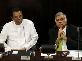 FILE- In this Oct. 3, 2017, file photo, Sri Lankan President Maithripala Sirisena, left, and Prime Minister Ranil Wickremesinghe attend a special session held to mark the country's seventieth anniversary of the first parliament of democracy, in Colombo, Sri Lanka. As lawmakers in Sri Lanka celebrate the 70th anniversary of the country's parliamentary democracy, one of the oldest in Asia, minorities including Tamils, Christians and Muslims remain on the fringes of society. (AP Photo/Eranga Jayawardena, File)