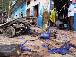 Residents walk at the scene of a deadly blast in Mogadishu, Somalia, on Oct. 29.