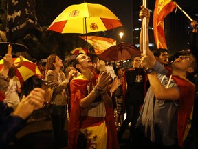 People gather on one of the city's main avenues to protest against Catalan government's push for secession from the rest of Spain in Barcelona, Spain, Wednesday, Oct. 18, 2017.
