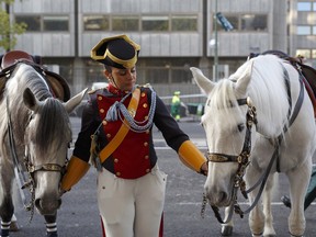 A female soldier holds two horses before the start of Spain's National Day military parade on October 12, 2017 in Madrid, which takes place as Spain faces a rise in tensions with Catalonia after the referendum vote for independence.