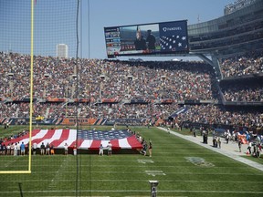 Fans watch the unfurled U.S flag on the field during the playing of the national anthem before an Chicago Bears-Pittsburgh Steelers game on Sept. 24.